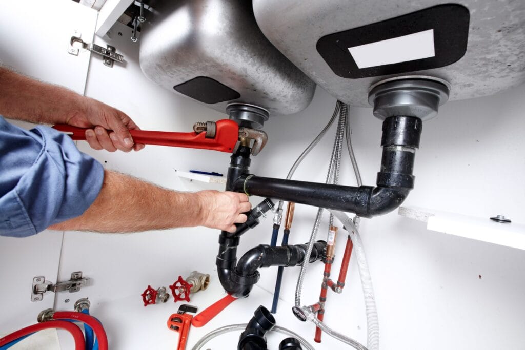 Lawrenceville Plumbing Pros fixing under sink plumbing and drain pipes