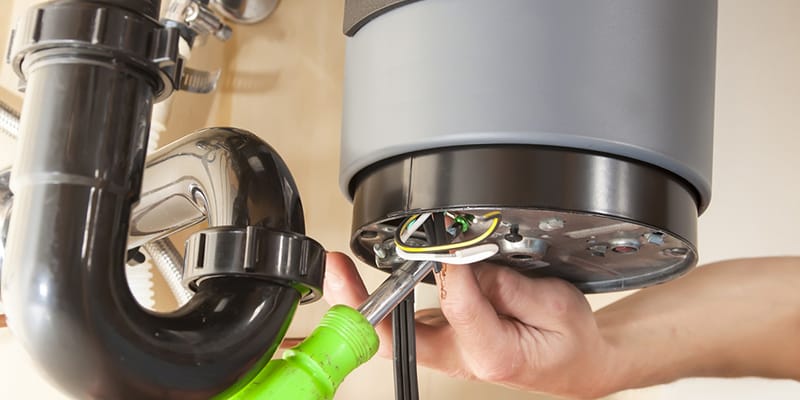 Technician repairing the heating element of a water heater in Lawrenceville